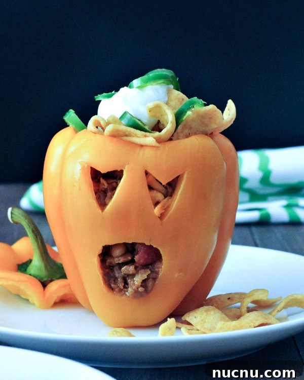 bell pepper jack o lanterns a bell pepper carved into a halloween jack o lantern, filled with Frito pie (chili and fritos)