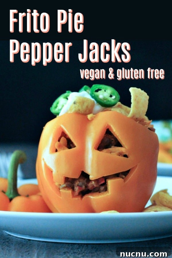 Frito Pie stuffed pepper jack o lanterns a bell pepper carved into a halloween jack o lantern, filled with Frito pie (chili and fritos)