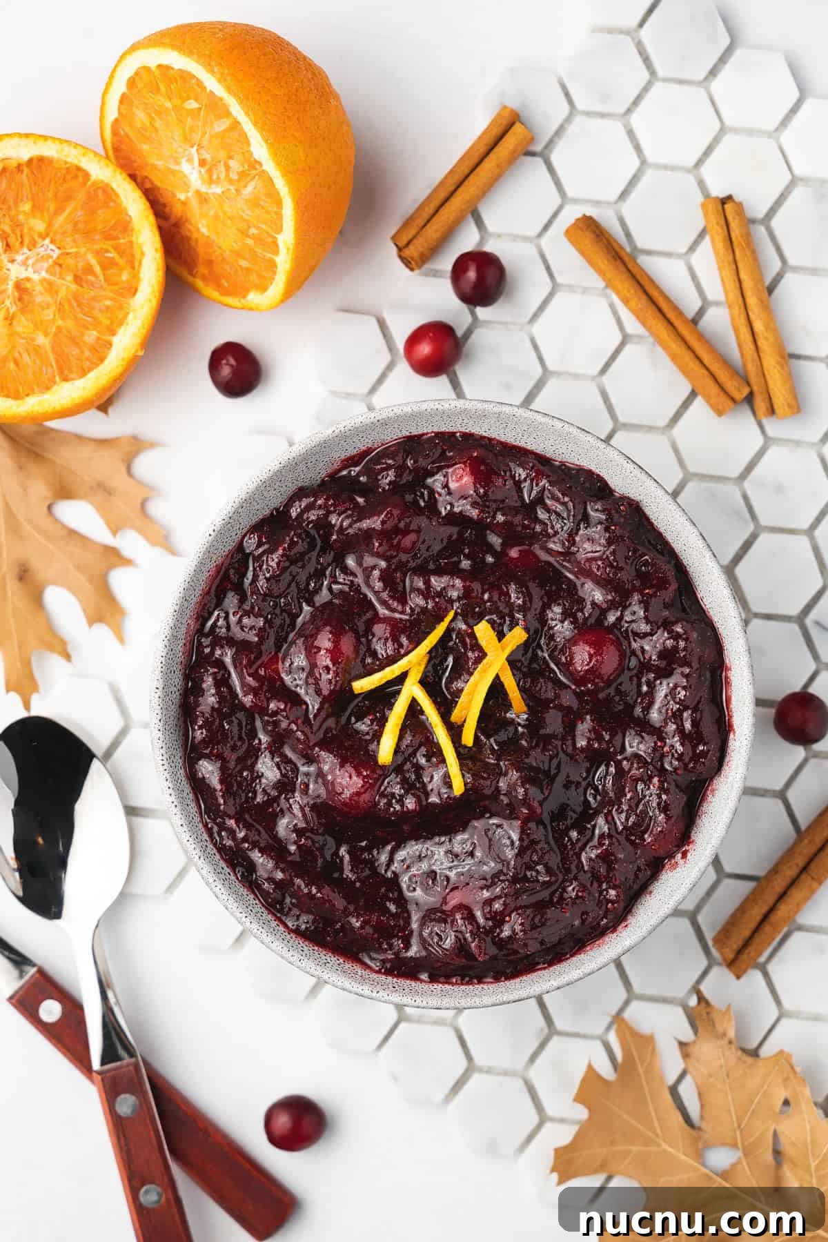 Slow-Cooker Cranberry Sauce for Thanksgiving and Holidays 2 Overhead view of a bowl of slow cooker cranberry sauce with orange zest as garnish.