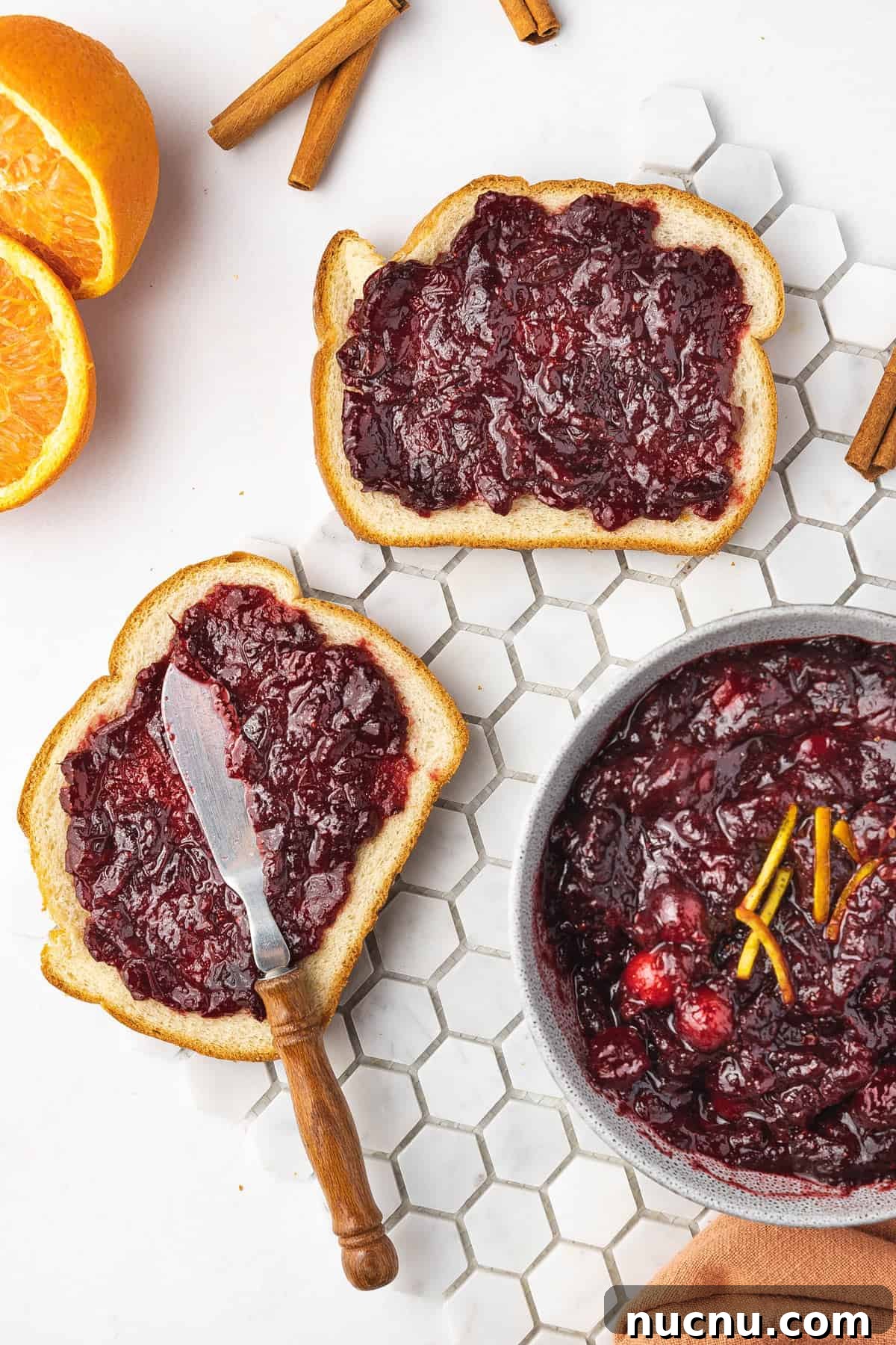 Slow-Cooker Cranberry Sauce for Thanksgiving and Holidays 8 Overhead view of two slices of bread with cranberry sauce spread on them.