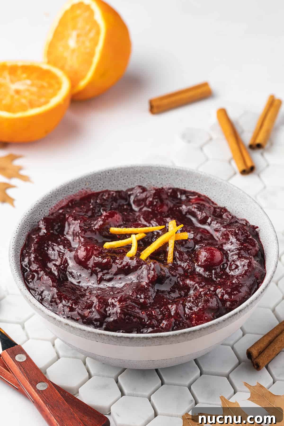 Slow-Cooker Cranberry Sauce for Thanksgiving and Holidays 9 An angled view of a bowl of crockpot cranberry sauce.