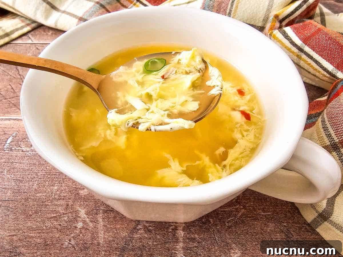 Classic Comfort: Homemade Egg Drop Soup Recipe 2 Egg Drop Soup on spoon