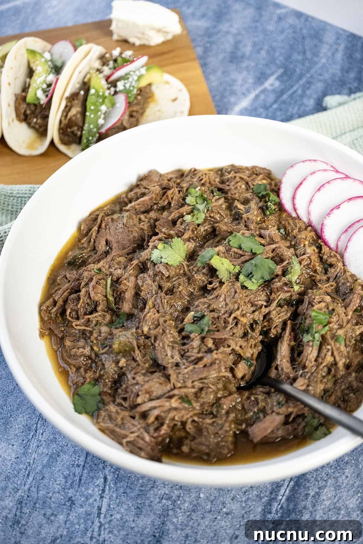 Dutch Oven Barbacoa Tacos Recipe — Tender Slow-Cooked Beef Tacos 2 Barbacoa in a bowl topped with cilantro