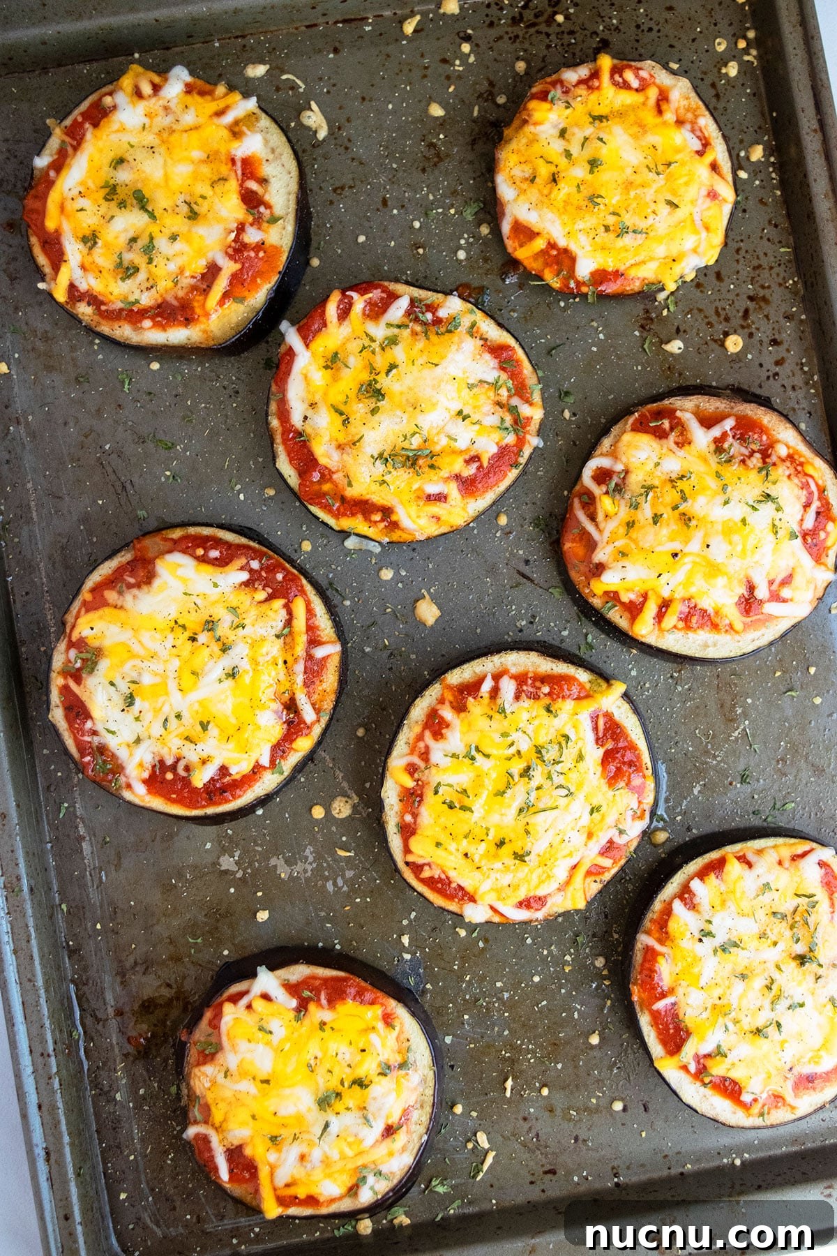 One-Pan Eggplant Pizza Recipe for Quick Weeknight Meals 5 Baked mini pizzas on tray.