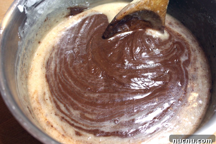 Decadent Chocolate Peppermint Fudge Recipe for the Holidays 3 Fudge ingredients cooking in a sauce pan.