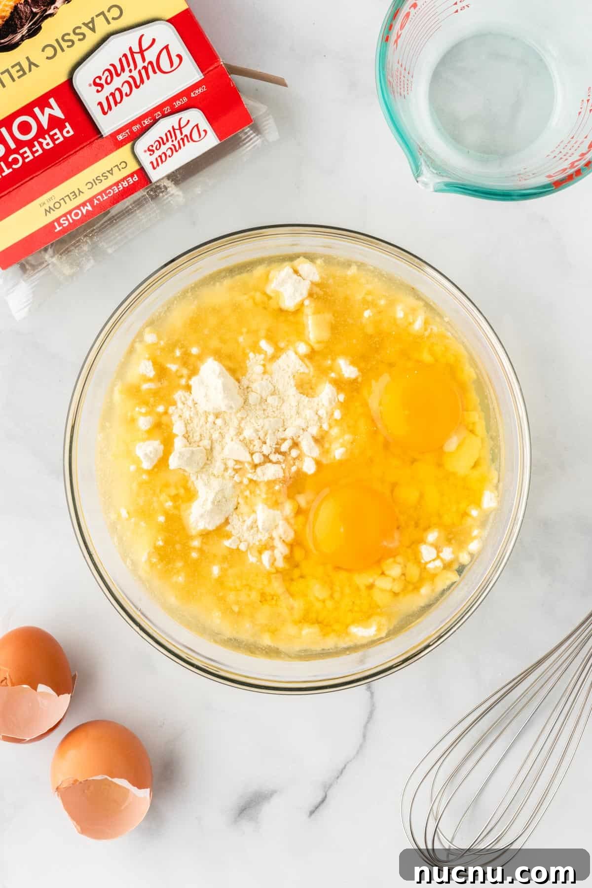 adding oil and eggs to the cake mix