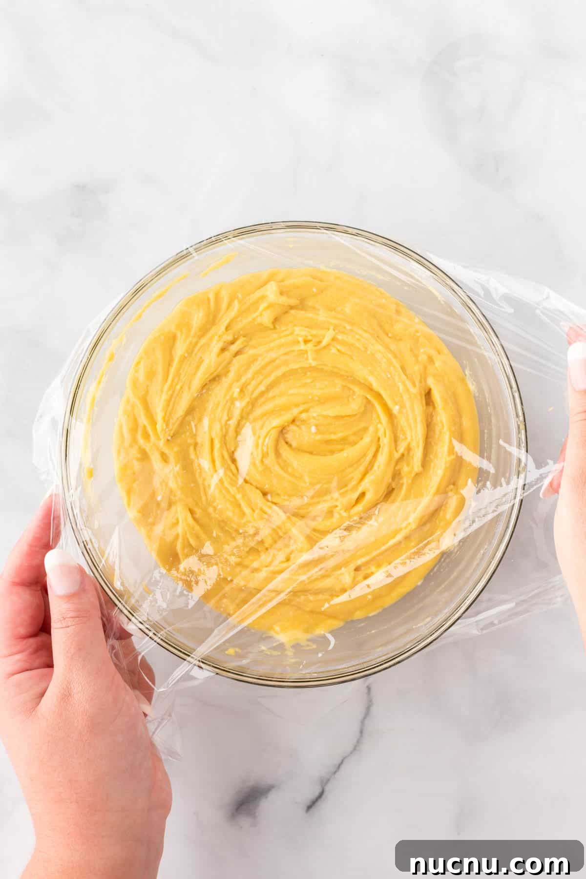 covering the cookie batter with cling wrap