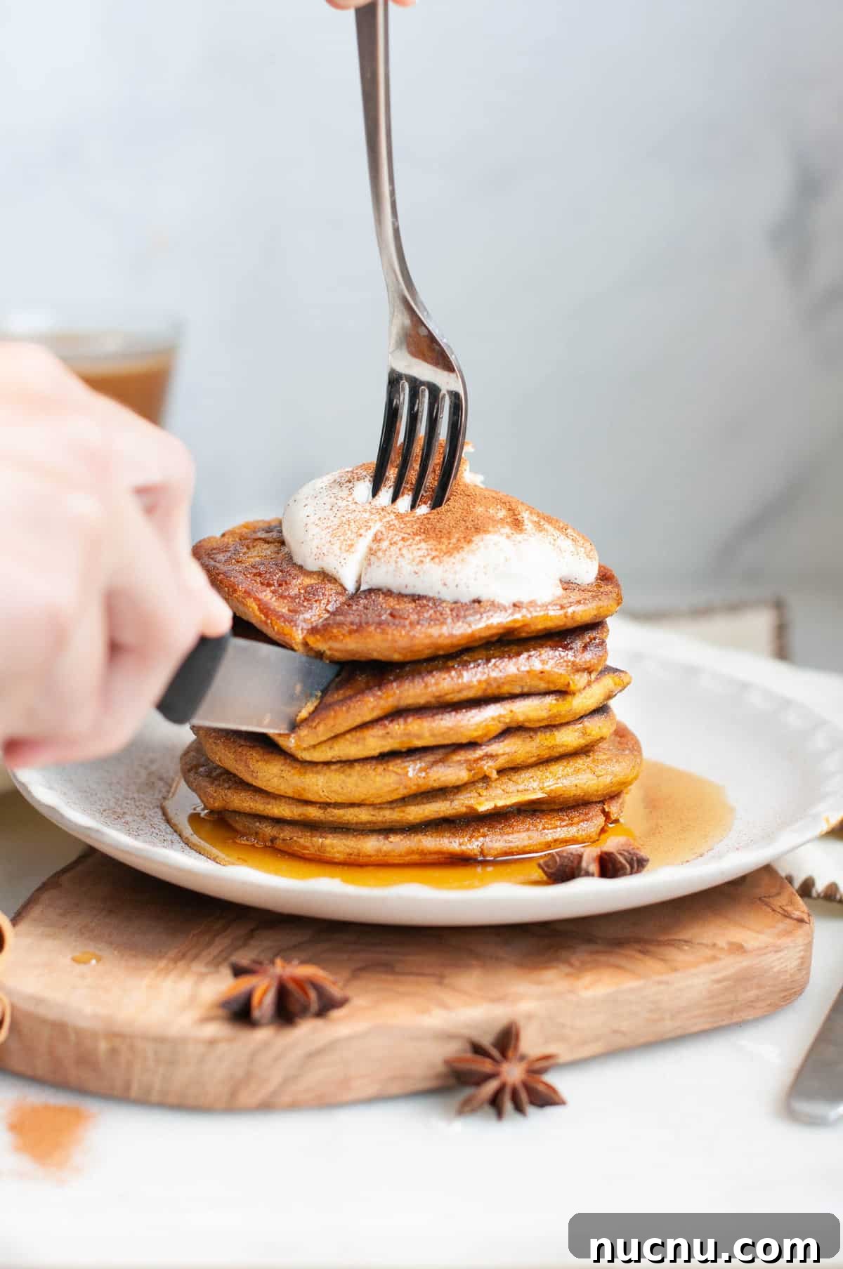 Fluffy Pumpkin Oatmeal Pancakes with Warm Spice 3 Pumpkin Pancakes stacked on a plate