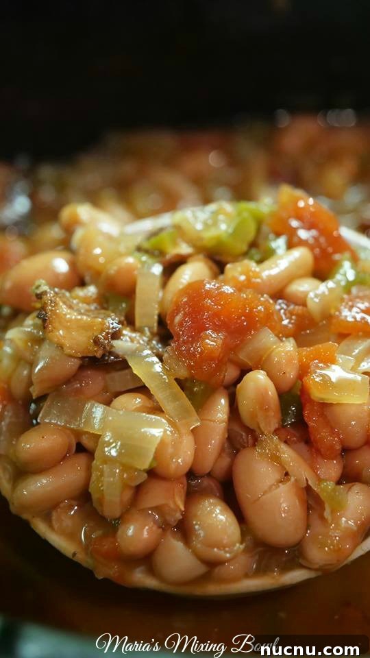 Slow Cooker Spicy Pinto Beans Recipe — Tender, Flavorful & Simple 5 cooked pinto beans loaded with sauted veggies and bacon in a slow cooker