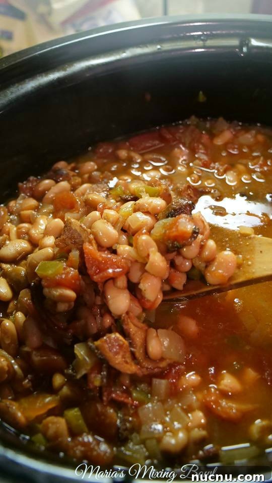 Slow Cooker Spicy Pinto Beans Recipe — Tender, Flavorful & Simple 10 wooden spoon scooping up pinto beans from slow cooker