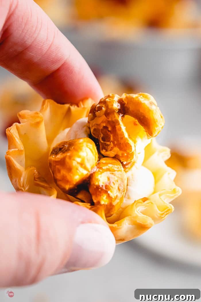 single caramel corn phyllo cup in a hand