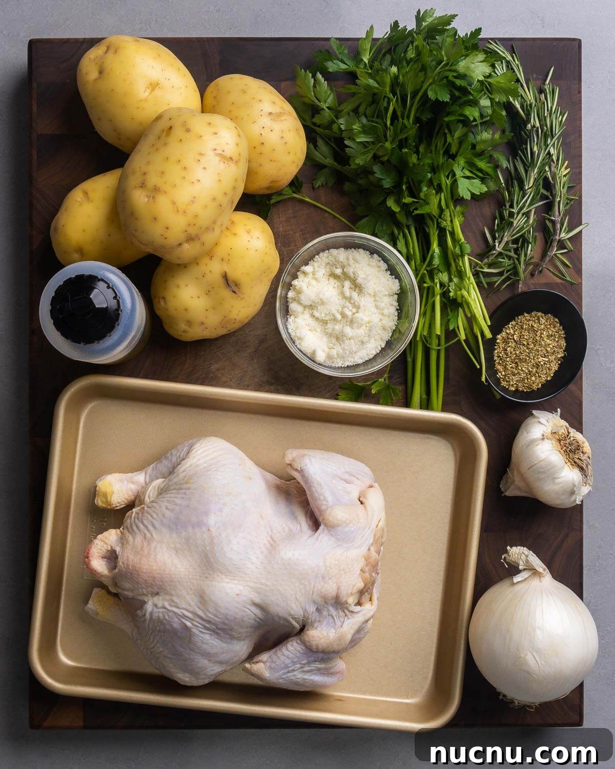 Ingredients shown: potatoes, olive oil, parsley, rosemary, oregano, Romano cheese, garlic, onion, and a whole chicken.