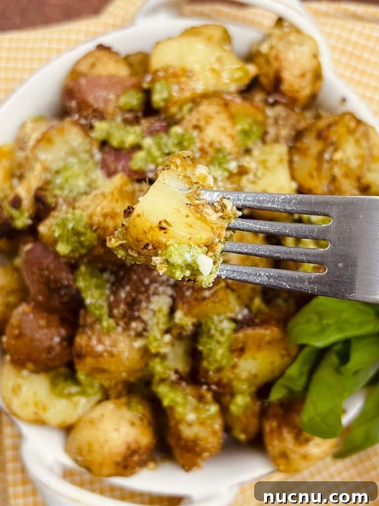 Crispy Pesto-Roasted Potatoes with Garlic and Parmesan 16 Pesto Roasted Potatoes Styled Photo on Fork.
