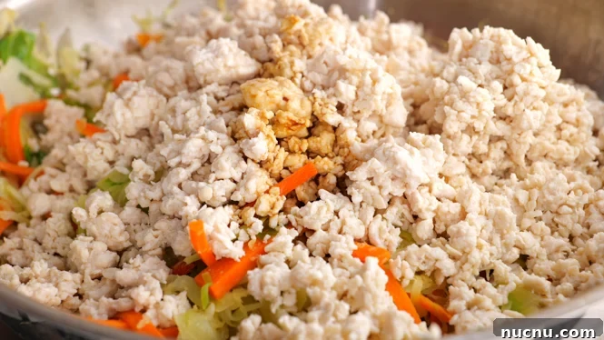 Deconstructed Egg Roll Bowl: Quick Pork and Cabbage Stir-Fry 4 adding sauce to ground chicken and vegetables