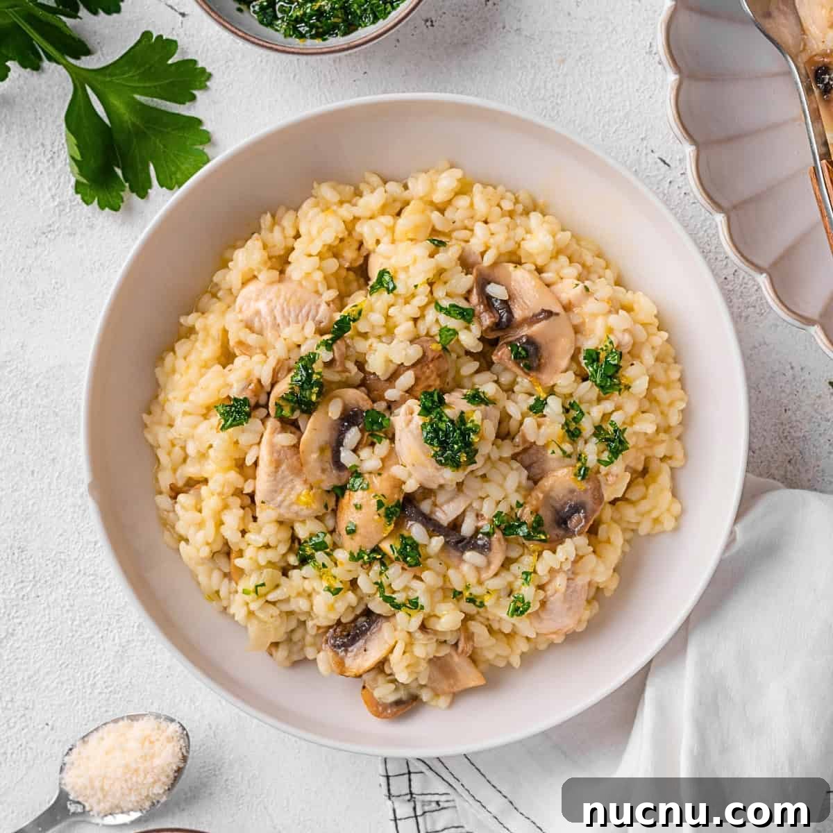 Creamy Chicken and Mushroom Risotto Recipe for Weeknight Dinner 2 Chicken and Mushroom Risotto served on a plate.