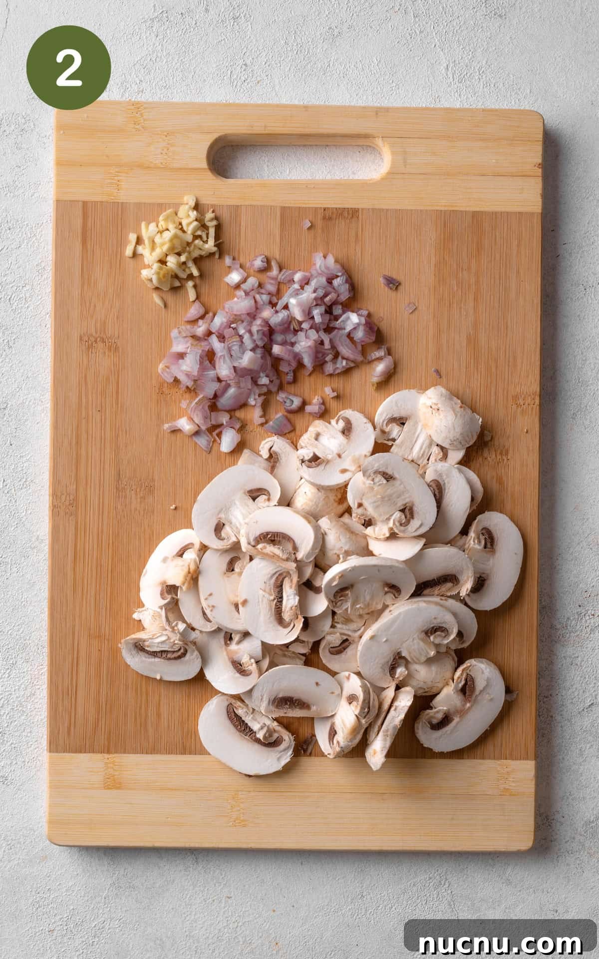 Creamy Chicken and Mushroom Risotto Recipe for Weeknight Dinner 5 onions, mushrooms and garlic on cutting board.