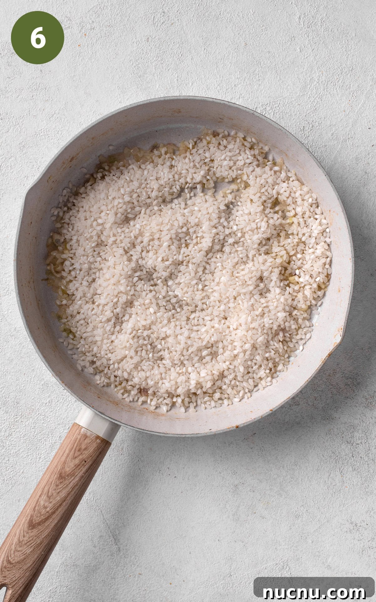 Creamy Chicken and Mushroom Risotto Recipe for Weeknight Dinner 9 cooking rice in a skillet.