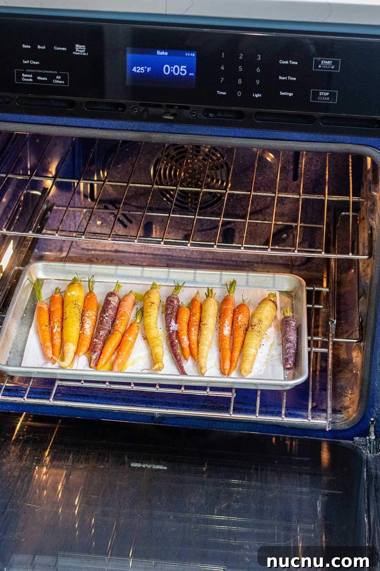 Roasted Rainbow Carrots with Garlic and Fresh Thyme 6 Rainbow carrots in an oven.
