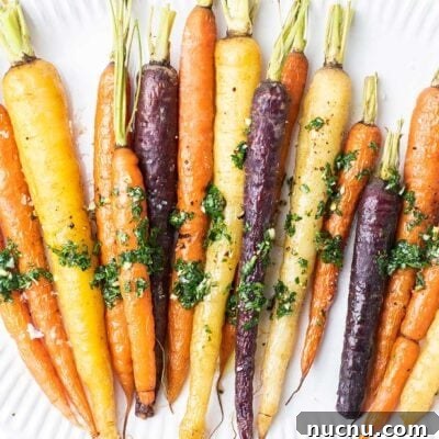 Roasted Rainbow Carrots with Garlic and Fresh Thyme 8 Roasted Rainbow Carrots shown drizzled with chimichurri.