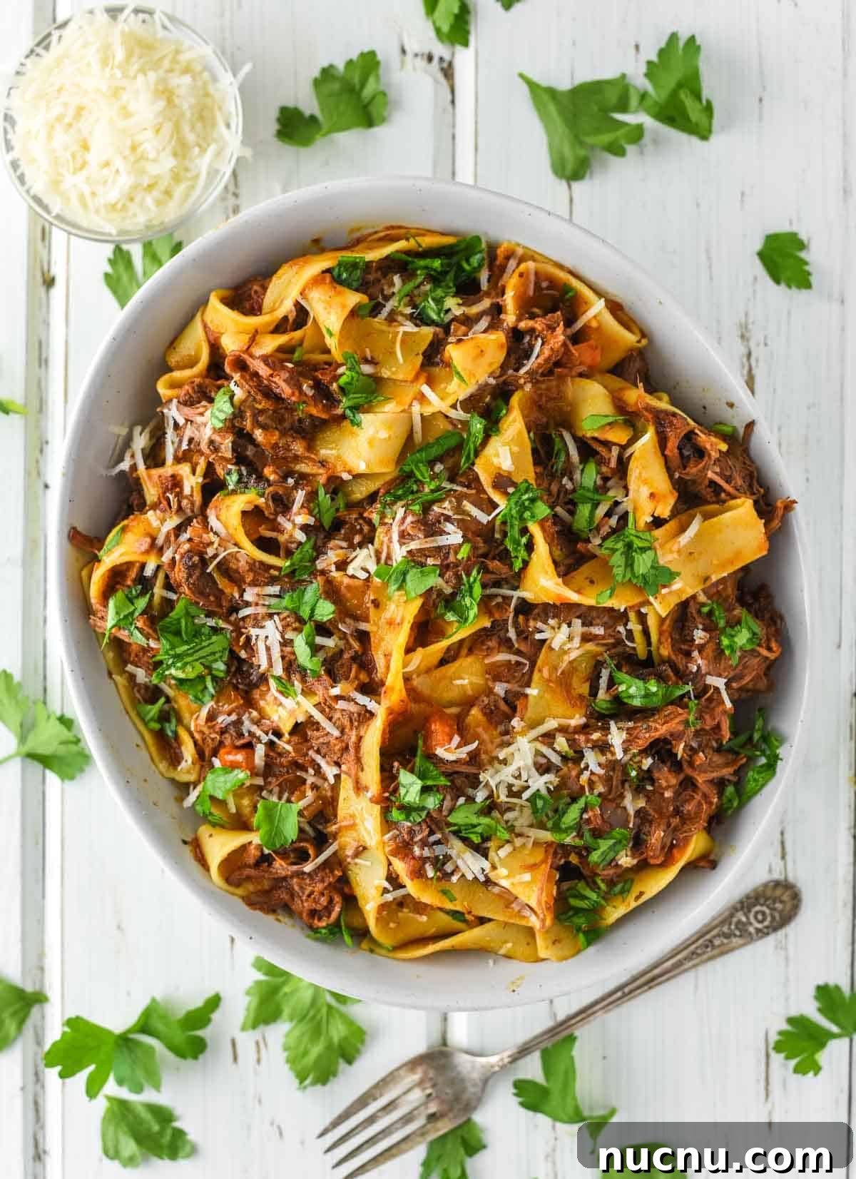 overhead shot of ragu with short ribs and pasta in bowl