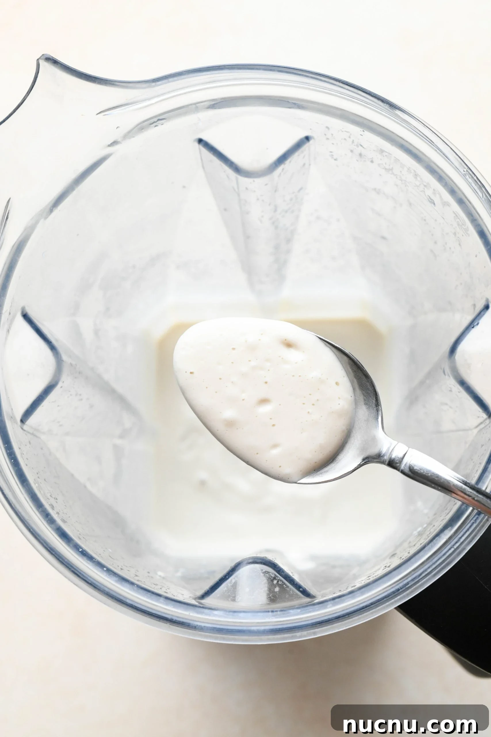 Creamy Raw Cashew Vegan Ranch Dressing Recipe 7 How to make vegan ranch dressing: A spoon lifting out blended c