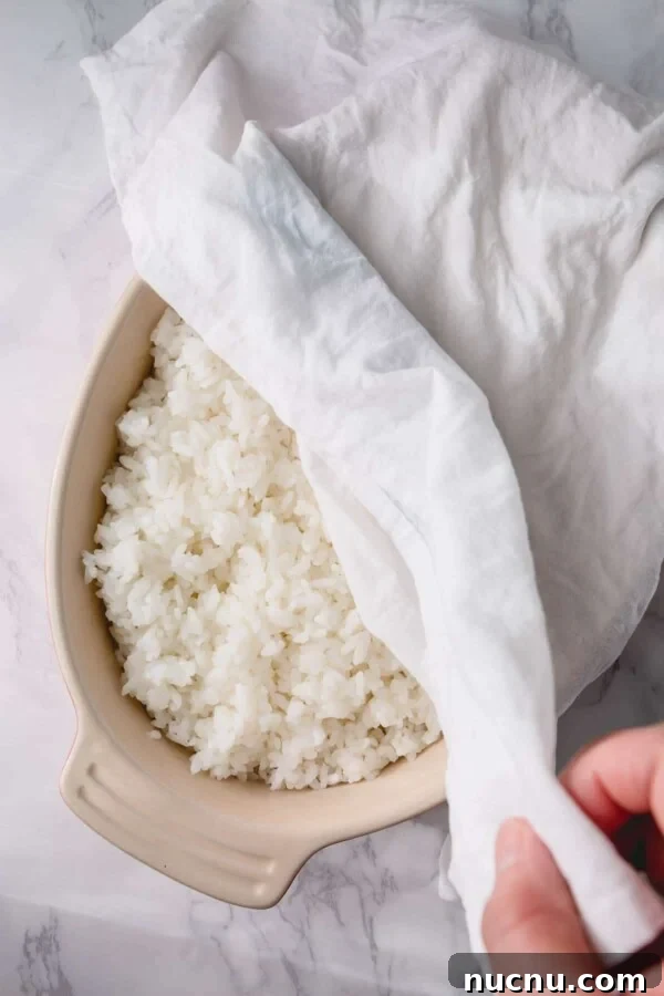 Perfect Sushi Rice: Step-by-Step Guide for Authentic Results 5 rice covered with a damp towel