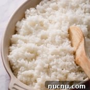Perfect Sushi Rice: Step-by-Step Guide for Authentic Results 8 sushi rice in a dish with a wooden spoon