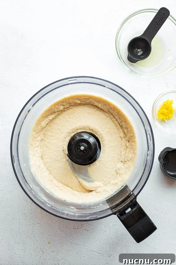 Butter bean mash with lemon juice and zest in a food processor.
