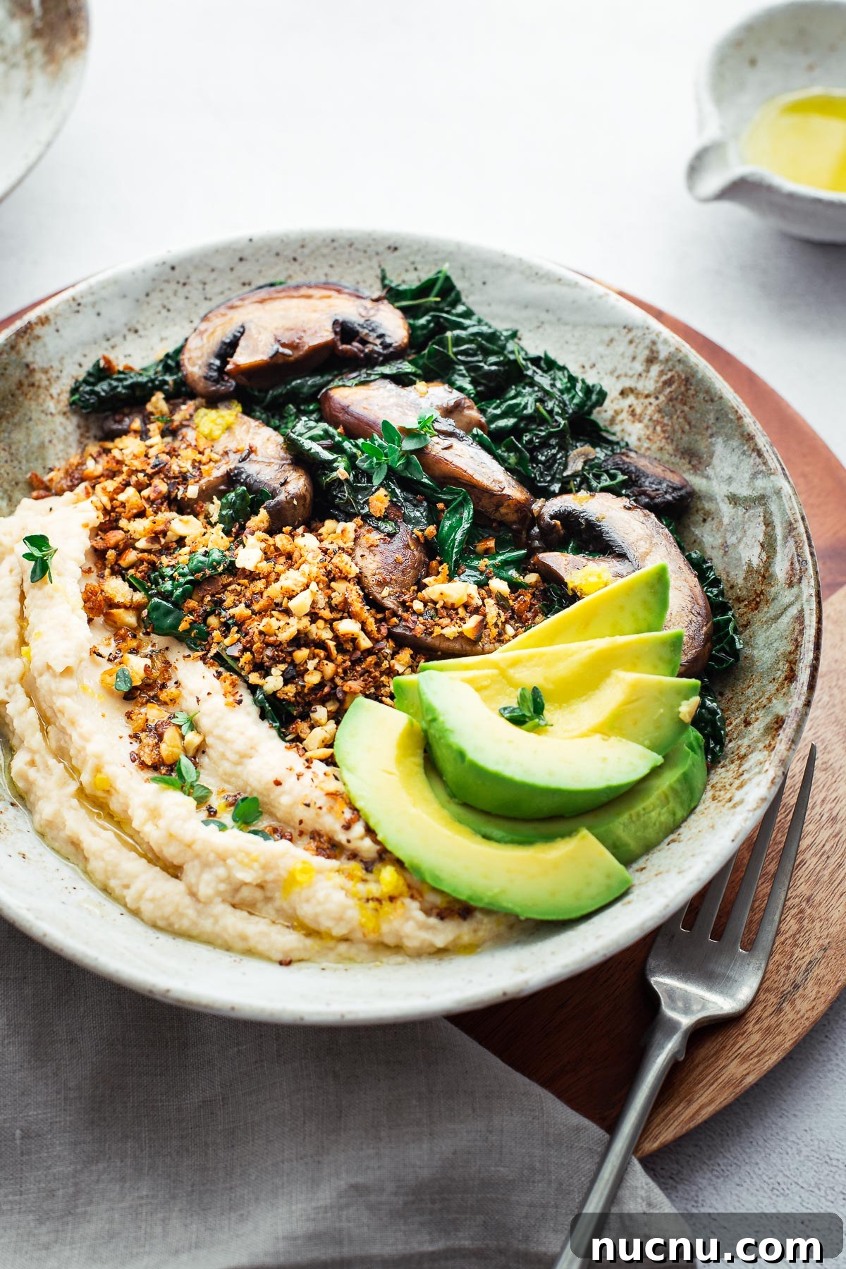 Butter bean mash, crumbs, sautéed mushrooms and kale with sliced avocado.