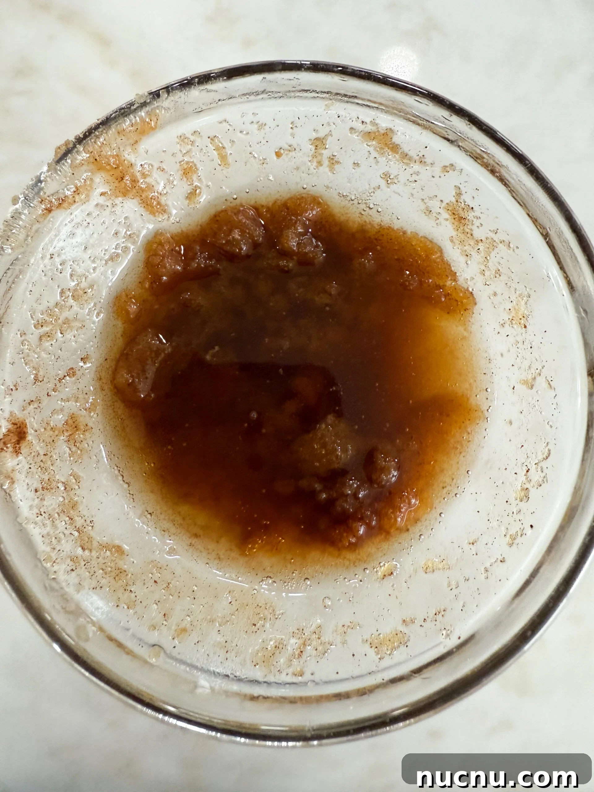 Melted butter, brown sugar, and cinnamon in a bowl for the donuts