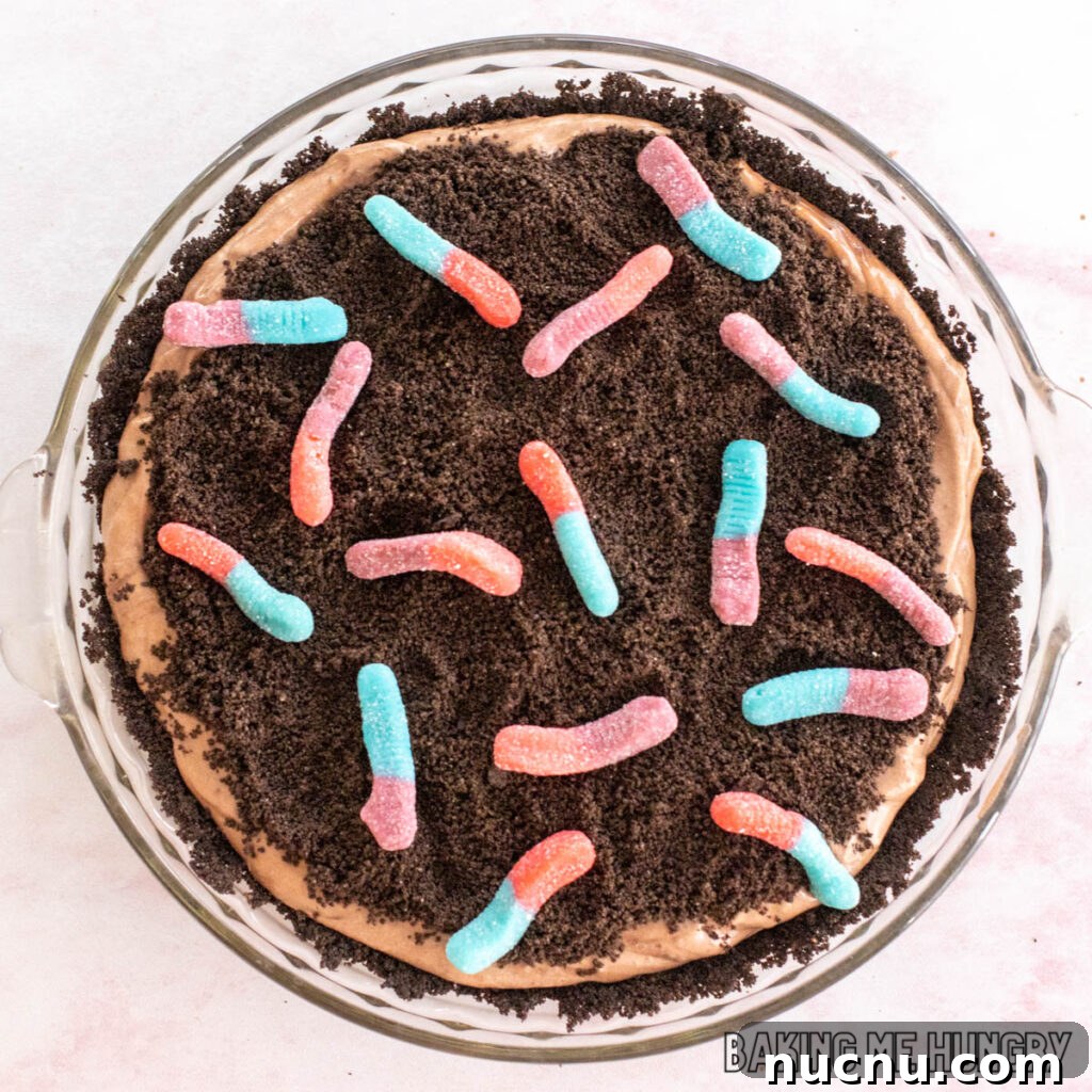 Decadent Chocolate Mud Pie Recipe: Creamy No-Bake Dessert 3 mud pie recipe with gummy worms shown from overhead in glass pie plate