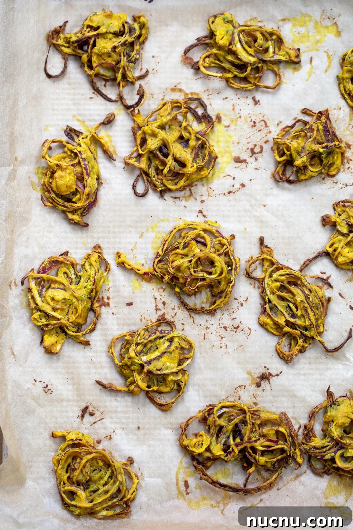 baked pakora freshly baked onion pakora on a baking sheet