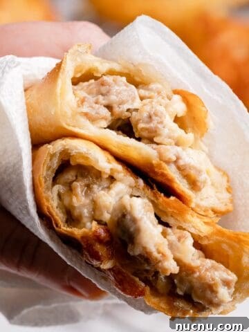 sausage and cheese turnover torn in half wrapped in paper towel