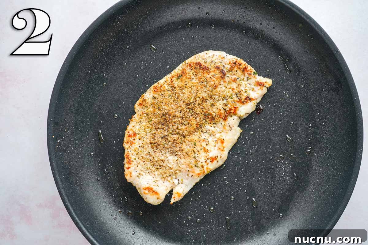 Caprese Chicken Sandwich with Fresh Mozzarella & Basil 5 seasoned cooked chicken breast in skillet