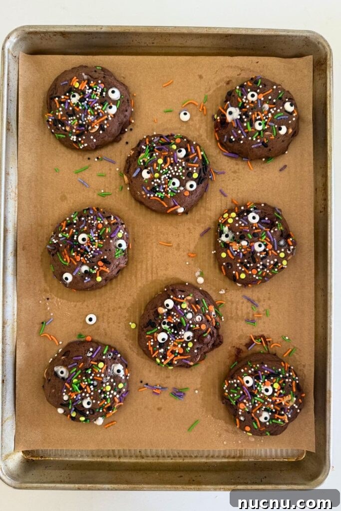 Baked sourdough Halloween cookies on parchment lined baking sheet.