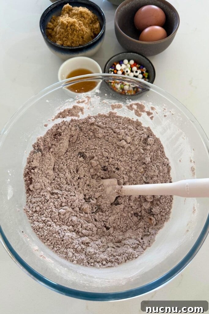 Dry ingredients for sourdough Halloween cookies in a glass bowl.