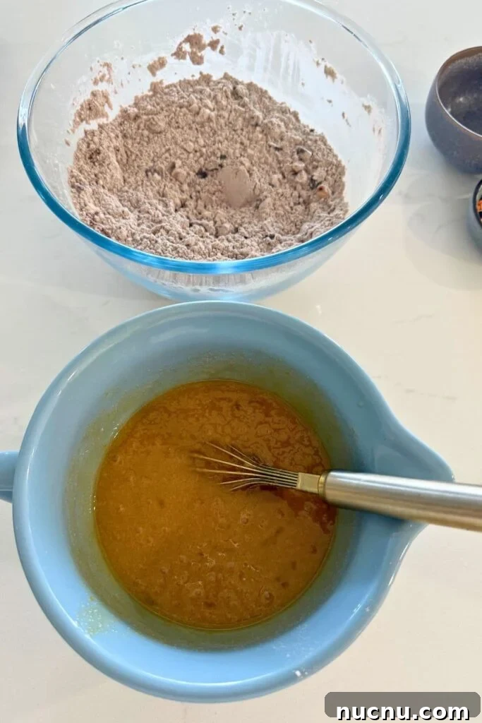 Wet ingredients in a bowl to make sourdough Halloween cookies.