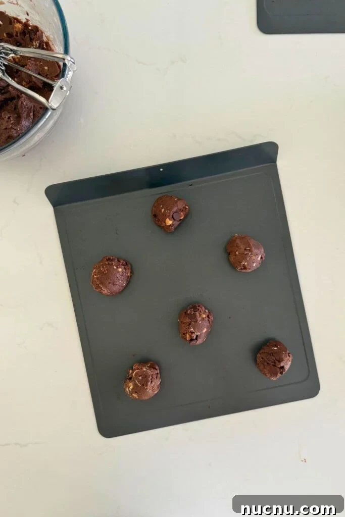 Cookie dough balls on baking sheet to make sourdough Halloween cookies.