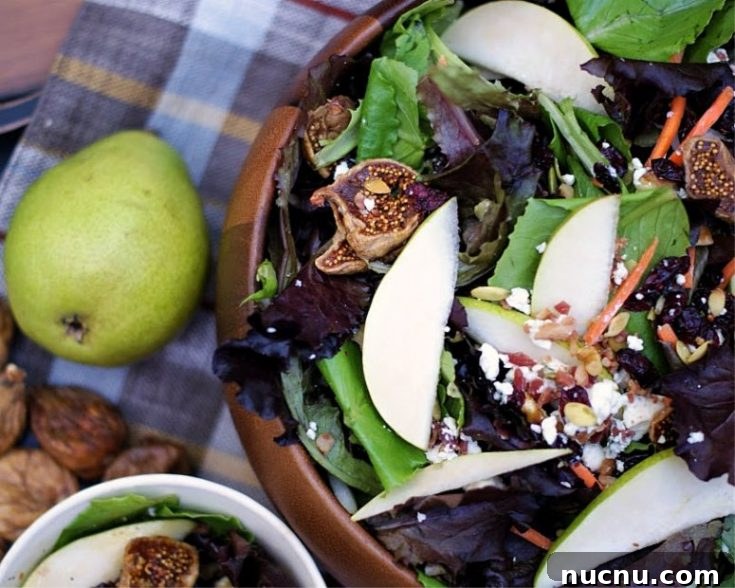Autumn pear salad in a wooden bowl.