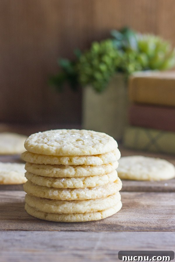 Bakery Style Sugar Cookies in a stack of seven, with more cookies in the background.  
