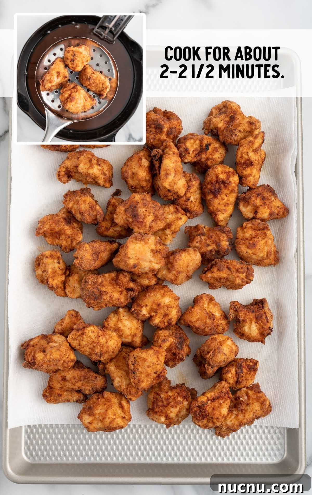 chicken nuggets in a parchment lined baking sheet