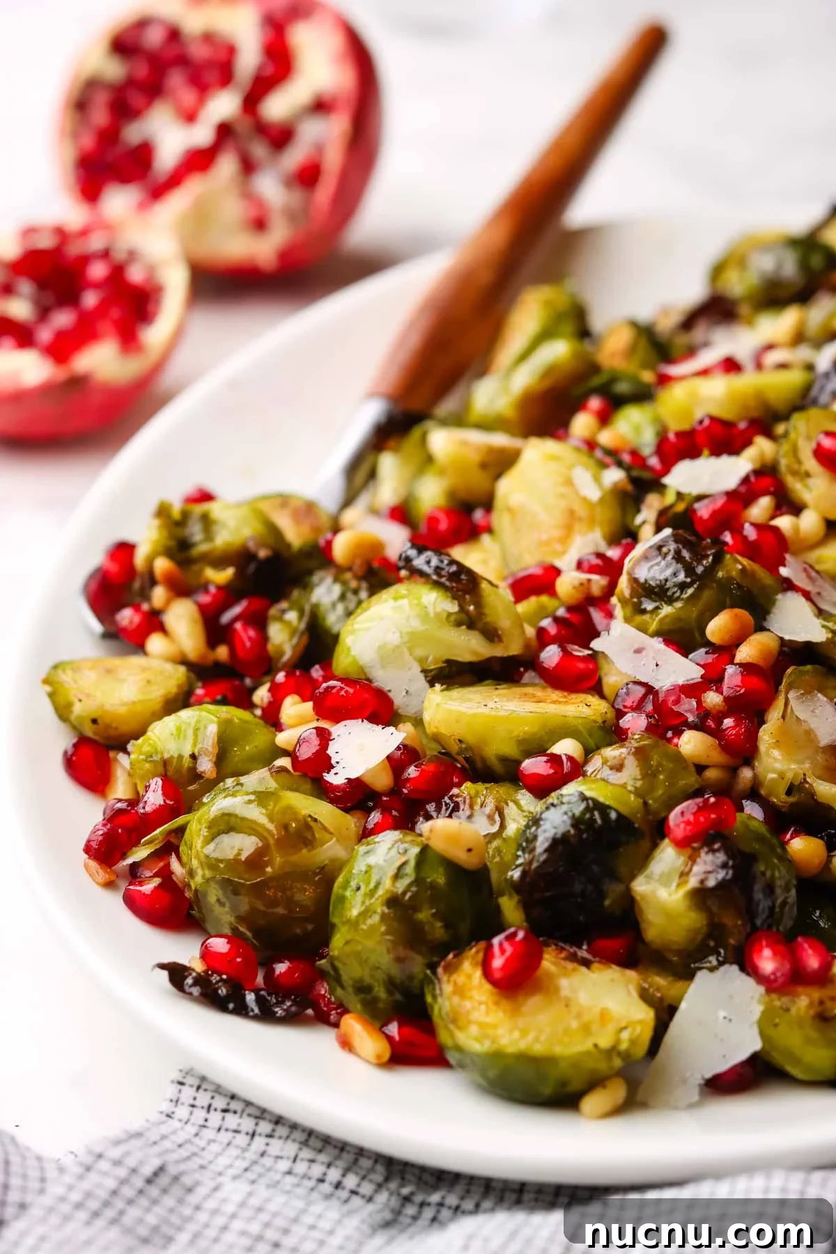closeup of.a dish served with roasted Brussels sprouts with pomegranates