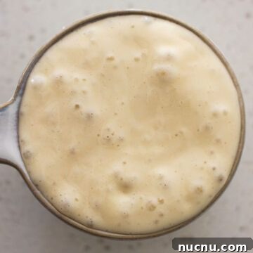 Active sourdought starter with bubbles.