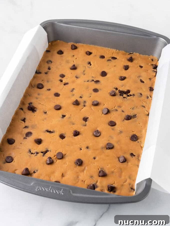 Chewy Peanut Butter Cookie Bars Recipe for Snack Lovers 7 peanut butter chocolate chip cookie dough in pan
