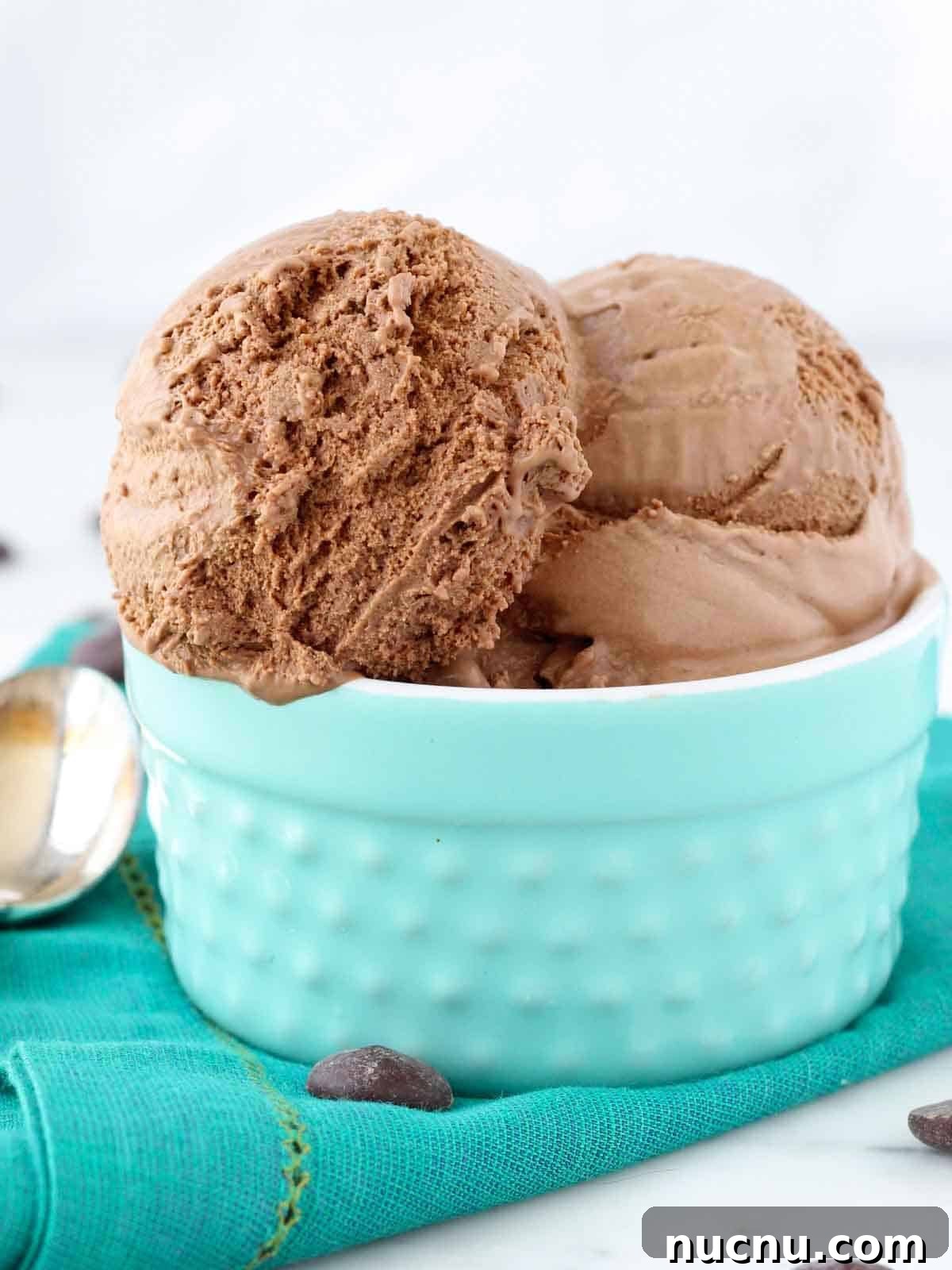 Homemade Rich Chocolate Ice Cream Recipe You’ll Love 3 3 scoops of chocolate ice cream in teal bowl.
