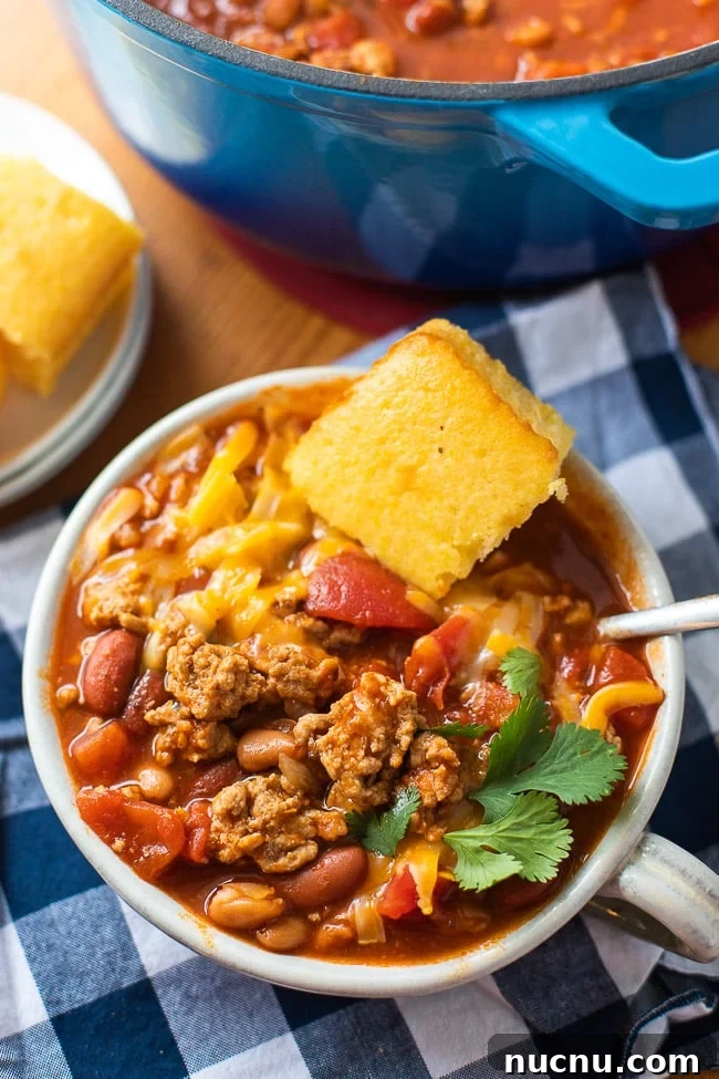 Hearty Ground Pork Chili Recipe for Cozy Weeknight Dinners 4 bowl of chili with cornbread