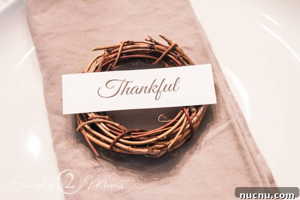 DIY Thanksgiving Place Cards: 3 Stylish Table Setting Ideas 9 close up of folded napkin with mini grapevine wreath and thankful tag