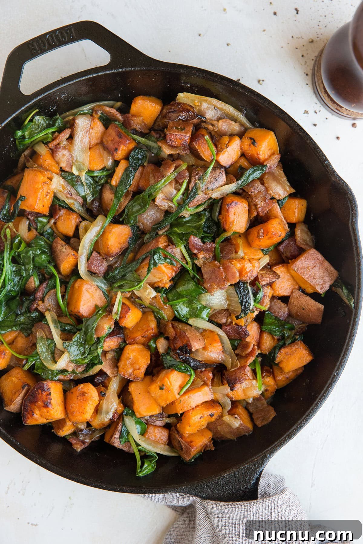 Sweet Potato Hash Recipe with bacon, onion, and spinach. This easy breakfast recipe results in perfectly crispy potatoes