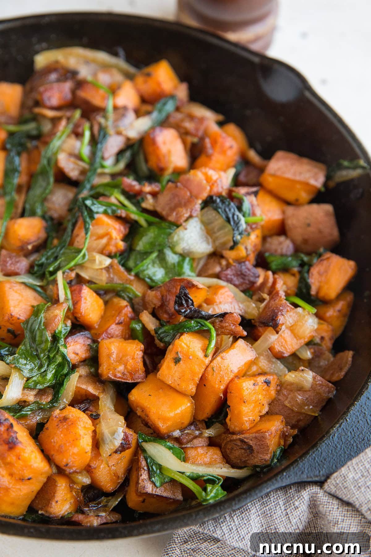 Easy Sweet Potato Hash Recipe with onions, bacon, and spinach
