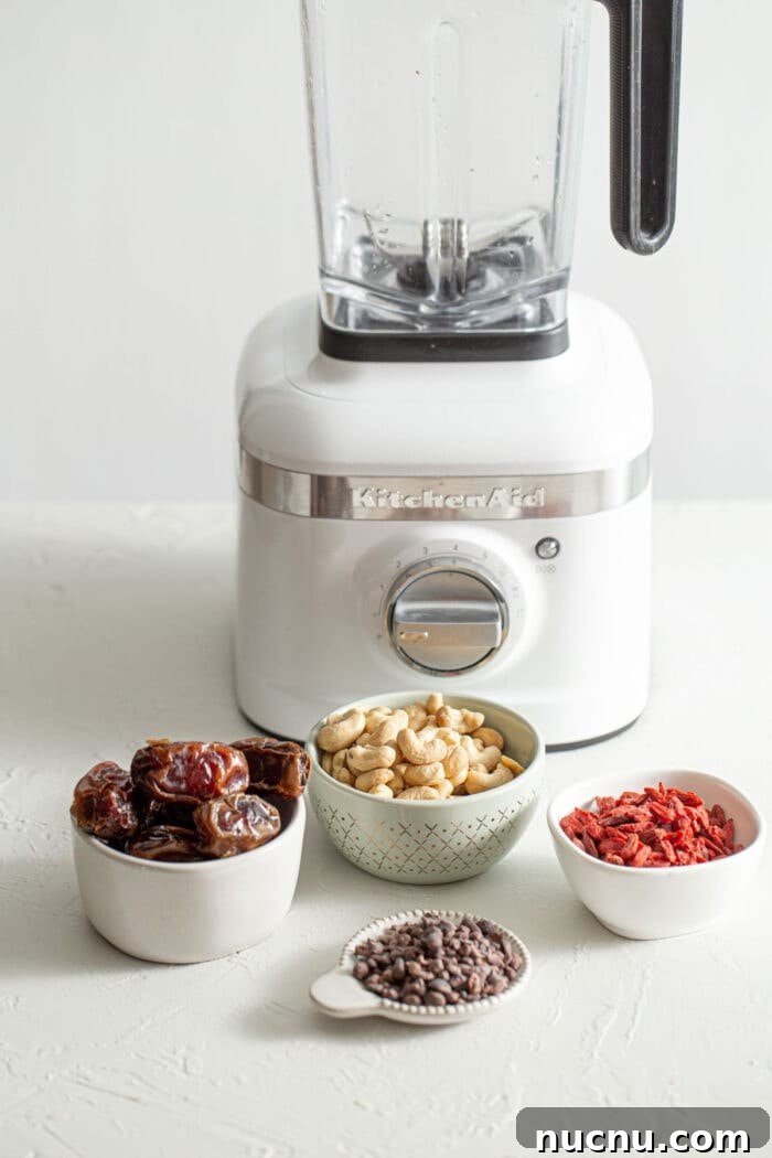 Essential Vegan Pantry Staples for Everyday Cooking 7 4 small bowls of dates, cashews, cacao nibs and goji berries.